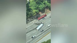 Lorry overturns and catches fire along highway in Malaysia