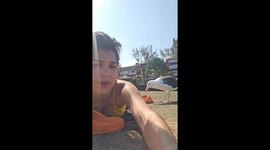 Seagull joins sunbather in Angra dos Reis, Brazil
