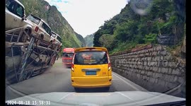 Man jumps from minivan to escape as trailer loaded with new cars flips onto it in China