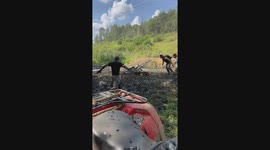 Motorbike riders attempt creek jump at Powerline Park during AWRCS racing