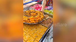 Hundreds of bees swarm around Thai street food desserts