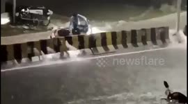 Onlookers rescue motorcycle rider swept away by flash flood