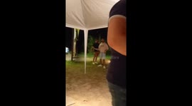 Person throws can into air and hits grill causing it to overturn