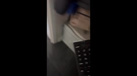 Girl tricks her boyfriend into talking to TV remote while he is asleep