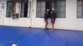 Firemen carry pet dog to safety from burning building