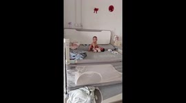 Elder brother comforts crying baby