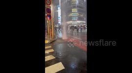 Water spurts out of drains as intense torrential rain causes flooding in Tokyo