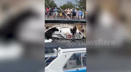 Video shows crowds gathering as boat gets stuck under bridge on idyllic Broads