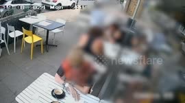 Dramatic moment two cars narrowly miss cafe-goers as they veer onto pavement