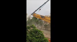 A hydraulic machine collapsed during metro construction, falling onto a nearby building due to a crane slip.