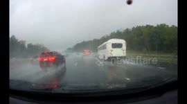 Truck Spins Out on Rainy Freeway