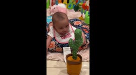 Child laughs while playing with voice-activated cactus toy in San Juan, Texas