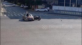 Motorcyclist somersaults over car bonnet and lands safely after dramatic crash in China