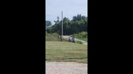 Children ride wheelchairs downhill in Paxton, Indiana