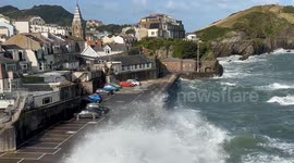 Waves crash onto parked cars in North Devon as Storm Lilian hits UK