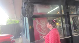 Woman Cooling Under Sprinkler in Texas