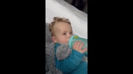 'Found the Off Button!' - Mom's gentle ear rub sends toddler to dreamland