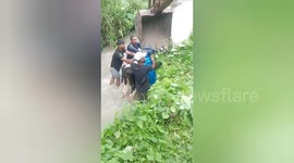 Fire Service police  rescued a cow with the help of rope and JCB machine and took them out of the canal in Northern India