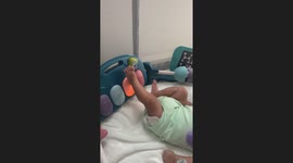 2-month-old discovers the joy of kicking toy to make sounds in adorable video