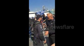 Israel: Israeli cop Meir Suissa throwing a stun grenade into protesters