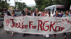 India: Citizens shout slogans and hold candles during a protest rally against the rape and murder of a PGT woman doctor in Kolkata