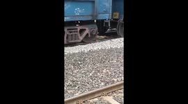 Woman lying on tracks avoids being crushed by goods train
