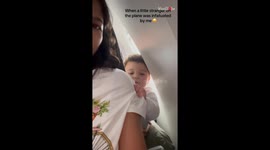 Little boy shows affection to a passenger on the Sydney-Melbourne plane