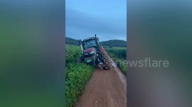 Farmer's tractor gets stuck in muddy field in China