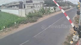 Motorcycle rider crashes into level crossing barrier at train approaches
