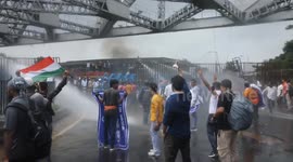 India: Police use a water cannon to disperse the members student organisation during a protest march