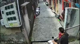 Motorcycle rider loses control of bike as he navigates alley