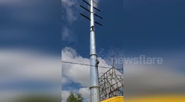 Policeman climbs 20 metres to save man stuck on high-voltage power pole in China