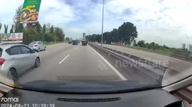 Signboard flies off truck and launches into oncoming traffic