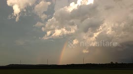 Rainbow developed as a severe storm was moving in the background