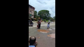 Locals wear fancy dress in colourful protest over potholes in India