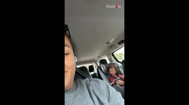Toddlers imitate head shakes to make each other laugh during a family trip