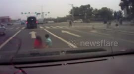 Three children drop out of minibus boot as it pulls away at traffic lights