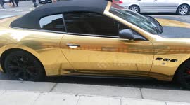 Gold plated supercar with 'L' plates and a parking ticket