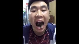Man swallows LIVE snake on camera