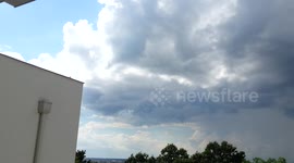 Half of the city with sunny weather, another half with storm