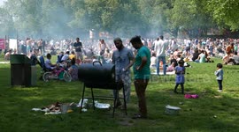 Londoners enjoy a barbecue on a hot day