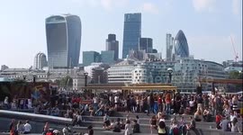 Londoners enjoy sunny day by Tower Bridge