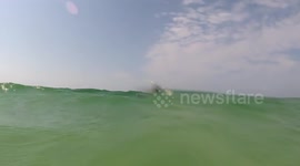 Wave flips kayaker