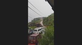 Mountain road collapses in front of stranded drivers in the Philippines