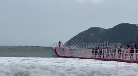 Tourists ride floating sea pontoon like a rollercoaster as 8ft waves break in China