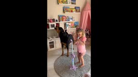 3-Year-old Gia and Rottweiler Zara sing together in Lusaka, Zambia