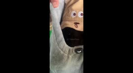 Shy bear cub hides in bag