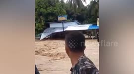 Homes collapsed and roads submerged as flash flood tears through Indonesia