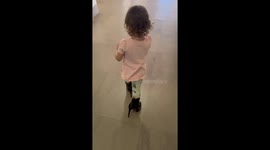 Little girl pretends to head out for a party in mom’s heels and lipstick