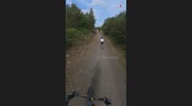 Riders entangled in a crash after a slowing rider lost control on jumps